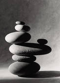 Black and white photo of smooth river rocks stacked into a pile