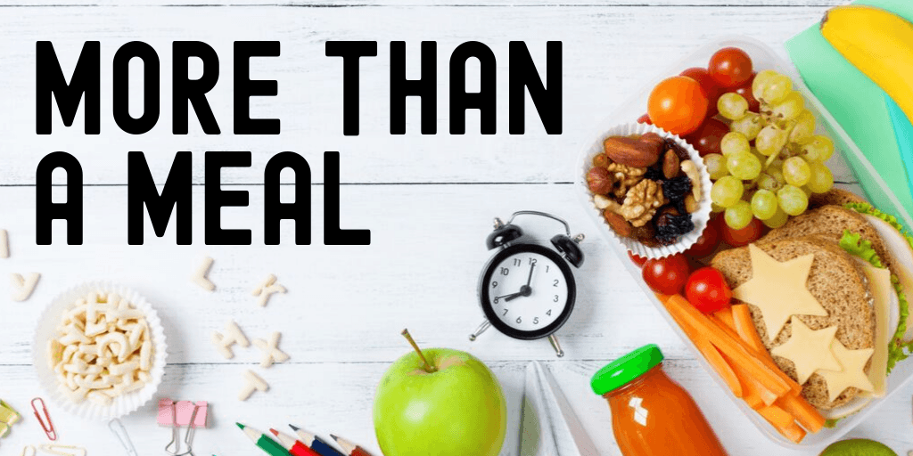 Kids lunch and school supplies on a white wood background with the words "MORE THAN A MEAL"